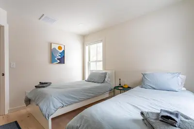 a bedroom with two beds and a window at Lakefront Cabin with Private Dock Kenoza Den in Jeffersonville