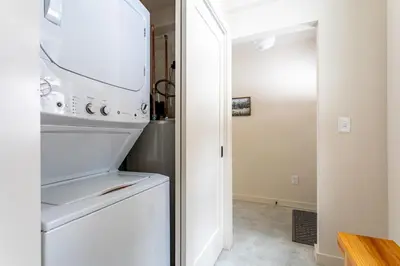 a white refrigerator freezer sitting inside of a kitchen at Lakefront Cabin with Private Dock Kenoza Den in Jeffersonville