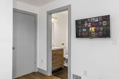 a bathroom with a sink and a mirror at 3BR Apt Mins to Bus Newark Airport Penn Sta NYC in Hillside