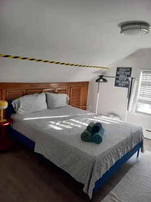 a bedroom with a bed with two towels on it at Cozy attic guest room in North Bergen