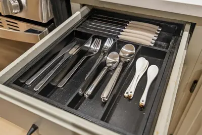 a drawer filled with silver utensils in an oven at Near to Manhattan PATH Train To NYC EWR in Harrison