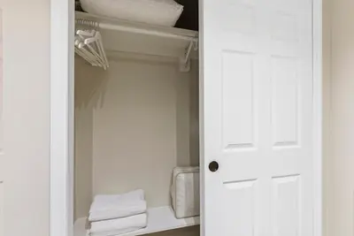 a closet with a white door and some towels at Near to Manhattan PATH Train To NYC EWR in Harrison