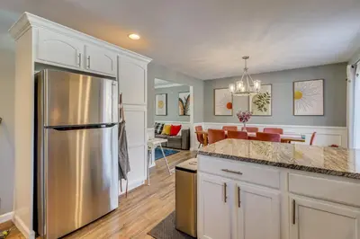 a kitchen with a stainless steel refrigerator and a dining room at Family Retreat with Game Room, 4 Mi to Kalahari! in Emerald Lakes