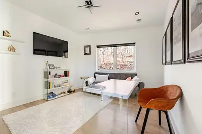 a living room with a white table and a chair at Modern Lakeview Home with Private Dock Sleeps 5 in Landing