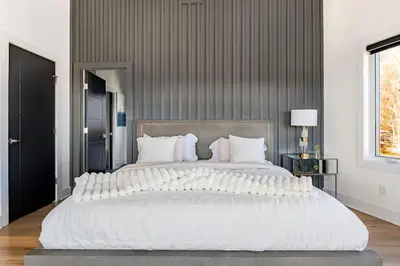 a large bed with white pillows in a bedroom at Modern Lakeview Home with Private Dock Sleeps 5 in Landing