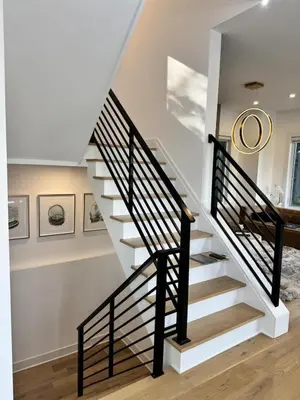 a staircase in a home with black and white railings at Modern Lakeview Home with Private Dock Sleeps 5 in Landing
