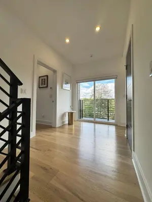 an empty living room with a staircase and a large window at Modern Lakeview Home with Private Dock Sleeps 5 in Landing