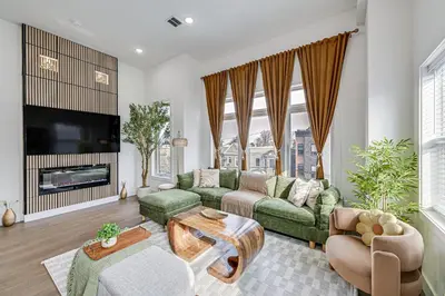 a living room with a couch and a tv at 6 Mi to Manhattan Luxe Apt with City Views! in Jersey City