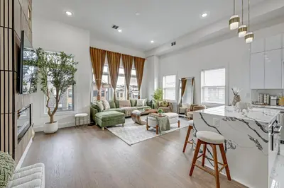a kitchen and living room with white walls at 6 Mi to Manhattan Luxe Apt with City Views! in Jersey City