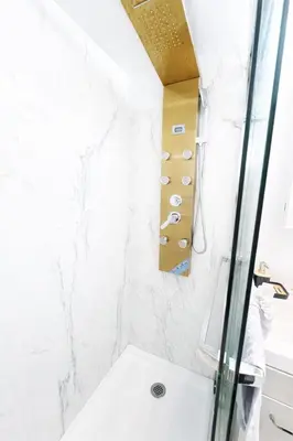 a bathroom with a shower and a sink at Manhattan Skyline Views Spacious 3BR in Jersey City