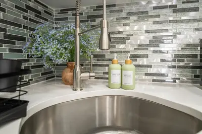 a kitchen sink with two shampoo bottles on it at 5 beds 7 person Prime Location Near Transit NYC in Jersey City