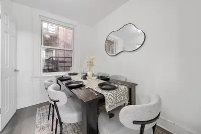 a dining room with a table and chairs at Spacious 3BR NYC Manhattan Skyline Views Nearby in West New York