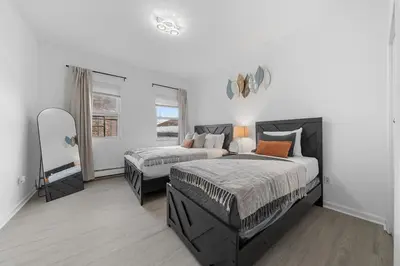 a bedroom with two beds and a window at Bright 4B - Full Kitchen -15 min to Mannhatan in Jersey City