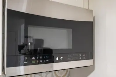 a microwave oven with a window in a kitchen at Fast access to NYC - family & group -skyline view in Jersey City