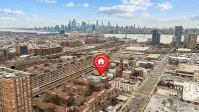 a red stop sign in the middle of a city at Fast access to NYC - family & group -skyline view in Jersey City