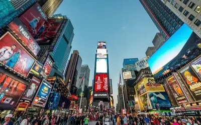 a crowd of people crossing a street in a city at 3-Bedroom 5-Beds JC Downtown 19Minutes Time Square in Jersey City