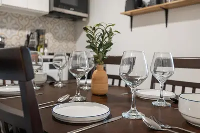 a table with wine glasses and plates on it at 3-Bedroom 5-Beds JC Downtown 19Minutes Time Square in Jersey City