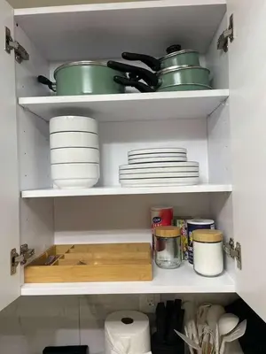 a kitchen cabinet with plates and bowls and dishes at 3-Bedroom 5-Beds JC Downtown 19Minutes Time Square in Jersey City