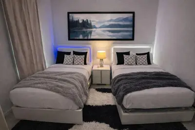 two beds in a small room with at 3-Bedroom 5-Beds JC Downtown 19Minutes Time Square in Jersey City