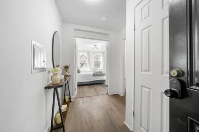 a hallway with a door leading to a bedroom at Modern 2BR Apartment - 15 min to NYC - Sleeps 6 in West New York