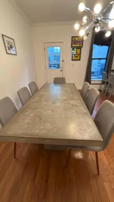 a dining room with a large table and chairs at Trendy 5-Bedroom Home in NYC Prime Location in New York
