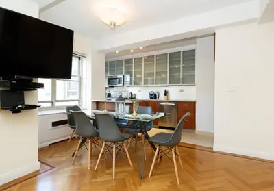 a kitchen and dining room with a table and chairs at Time Square Vicinity- Luxury 2BR 2BA NYC Apt in New York
