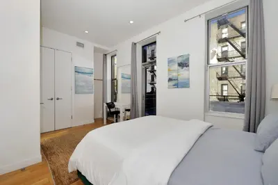 a white bedroom with a bed and a window at Time Square Vicinity- Luxury 2BR 2BA NYC Apt in New York