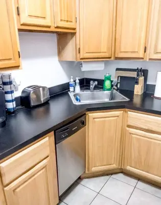 a kitchen with a sink and a dishwasher at Spacious Stay 3 BR in Prime Location of NYC in New York