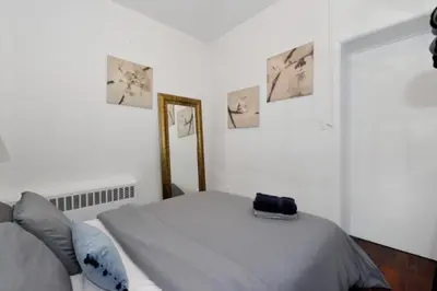 a bedroom with a bed and pictures on the wall at Spacious Stay 3 BR in Prime Location of NYC in New York