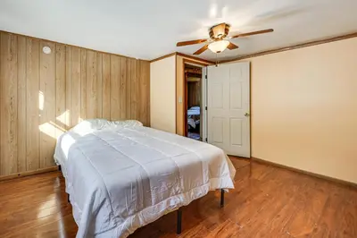 a bedroom with a bed and a ceiling fan at Group Getaway with Fire Pit Near Susquehanna River! in Danville