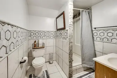 a bathroom with a toilet and a shower and a sink at Group Getaway with Fire Pit Near Susquehanna River! in Danville