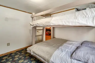a bedroom with two bunk beds and a ladder at Group Getaway with Fire Pit Near Susquehanna River! in Danville