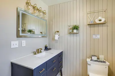 a bathroom with a sink and a mirror and a toilet at Walk to Public Transit Family Home in Mount Airy! in Philadelphia