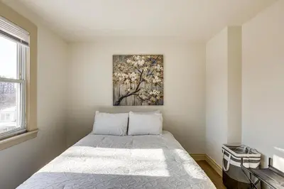 a bedroom with a bed with a painting on the wall at Walk to Public Transit Family Home in Mount Airy! in Philadelphia