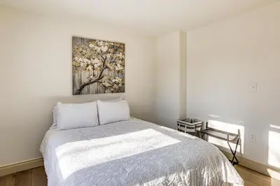 a bedroom with a bed and a painting on the wall at Walk to Public Transit Family Home in Mount Airy! in Philadelphia