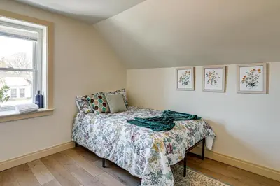 a small bedroom with a bed and a window at Walk to Public Transit Family Home in Mount Airy! in Philadelphia