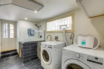 a laundry room with a washing machine and a window at Walk to Public Transit Family Home in Mount Airy! in Philadelphia