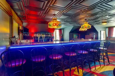 a bar with purple stools in a room at Fun and Unique Home with Vintage Game Room in Annville in Annville