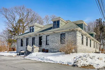 a stone house in the snow on a street at Fun and Unique Home with Vintage Game Room in Annville in Annville