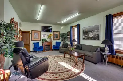 a living room with a couch and a table at Fun and Unique Home with Vintage Game Room in Annville in Annville