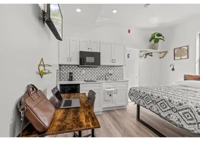a bedroom with a bed and a table with a laptop at Liberty bell GSN Harvest 1 in Philadelphia