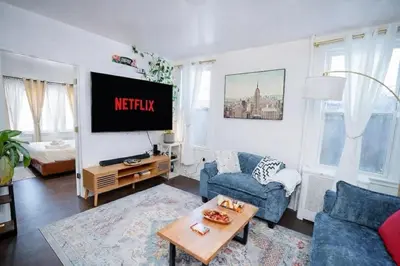 a living room with a couch and a tv at Pet Friendly Jersey City Apartment Near NYC Sleeps 6 with Easy Manhattan Access in Jersey City