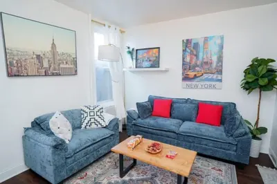 a living room with two blue couches and a coffee table at Pet Friendly Jersey City Apartment Near NYC Sleeps 6 with Easy Manhattan Access in Jersey City