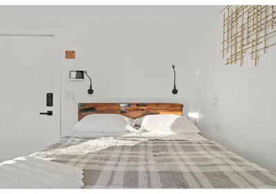 a white bedroom with a large bed with a wooden headboard at Philadelphia Rocky steps GSN Harvest 2 in Philadelphia