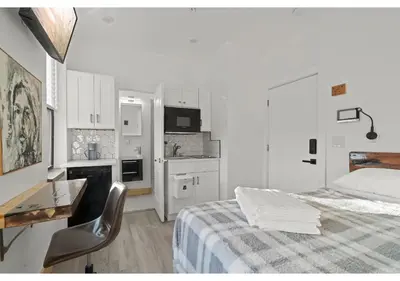 a bedroom with a bed and a desk and a kitchen at Philadelphia Rocky steps GSN Harvest 2 in Philadelphia