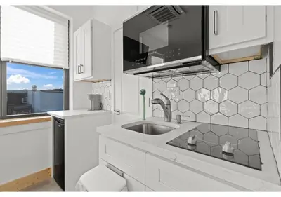 a white kitchen with a sink and a window at Philadelphia Rocky steps GSN Harvest 2 in Philadelphia