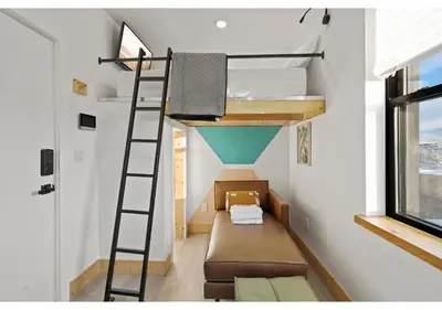 a tiny house with a loft bed and a couch at The Franklin institute GSN Harvest 3 in Philadelphia