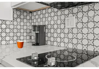 a kitchen with black and white tiles on the wall at Center city Philadelphia GSN Harvest 4 in Philadelphia