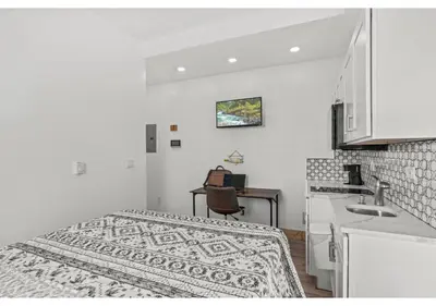 a small white room with a bed and a kitchen at Center city Philadelphia GSN Harvest 4 in Philadelphia