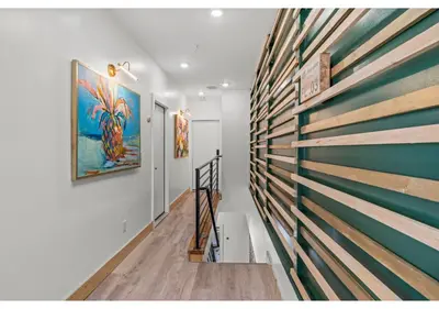 a hallway with a wooden wall with a painting on it at Center city Philadelphia GSN Harvest 4 in Philadelphia